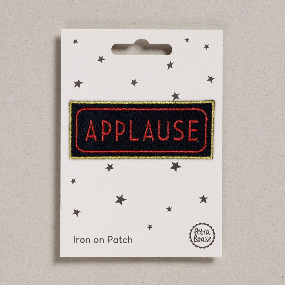 Applause embroidered iron on patch.