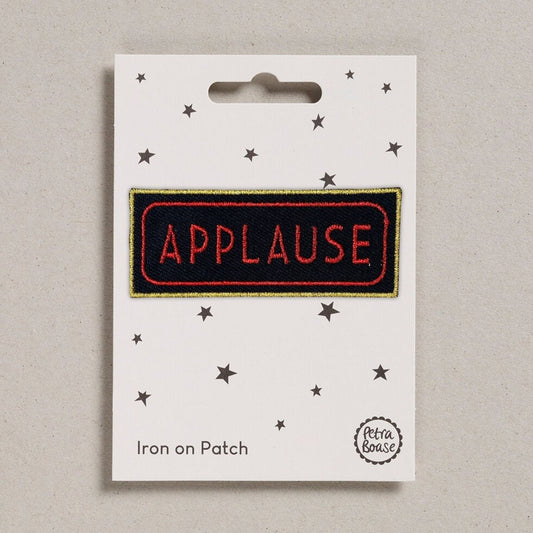 Applause embroidered iron on patch.