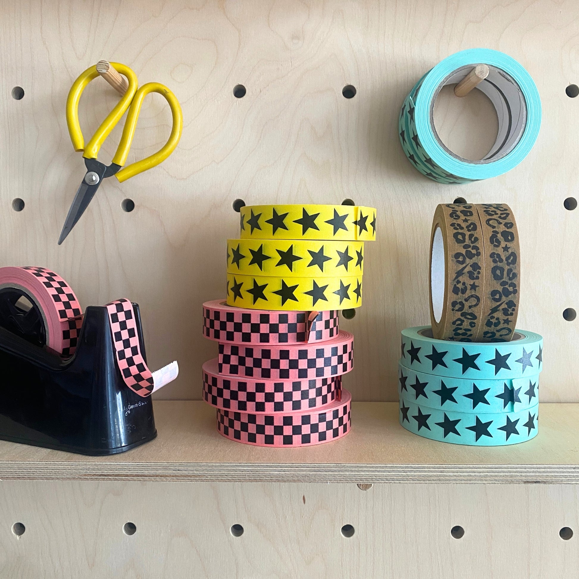 Eco paper adhesive tape in lots of fun colours and Patterns, 50m per roll on a shelf.