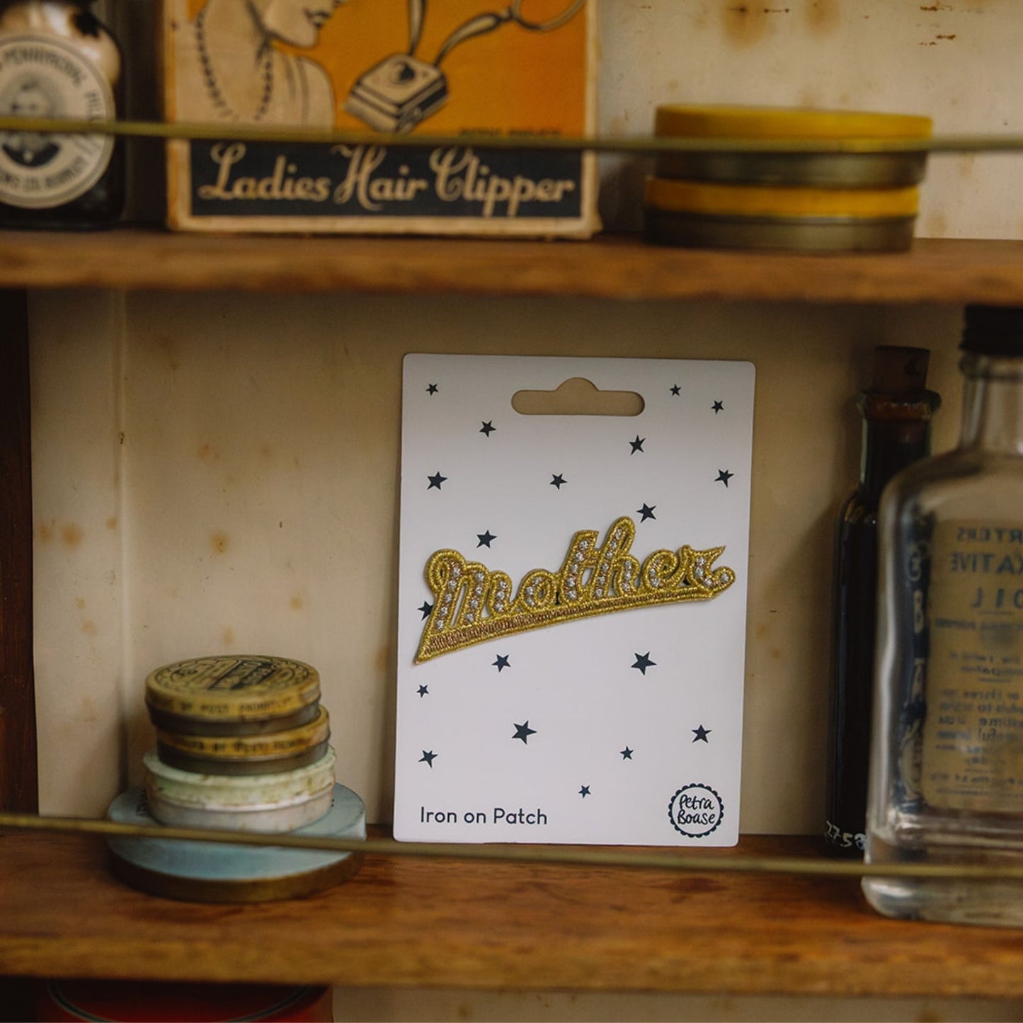 Embroidered gold mother retro patch in a vintage cuboard