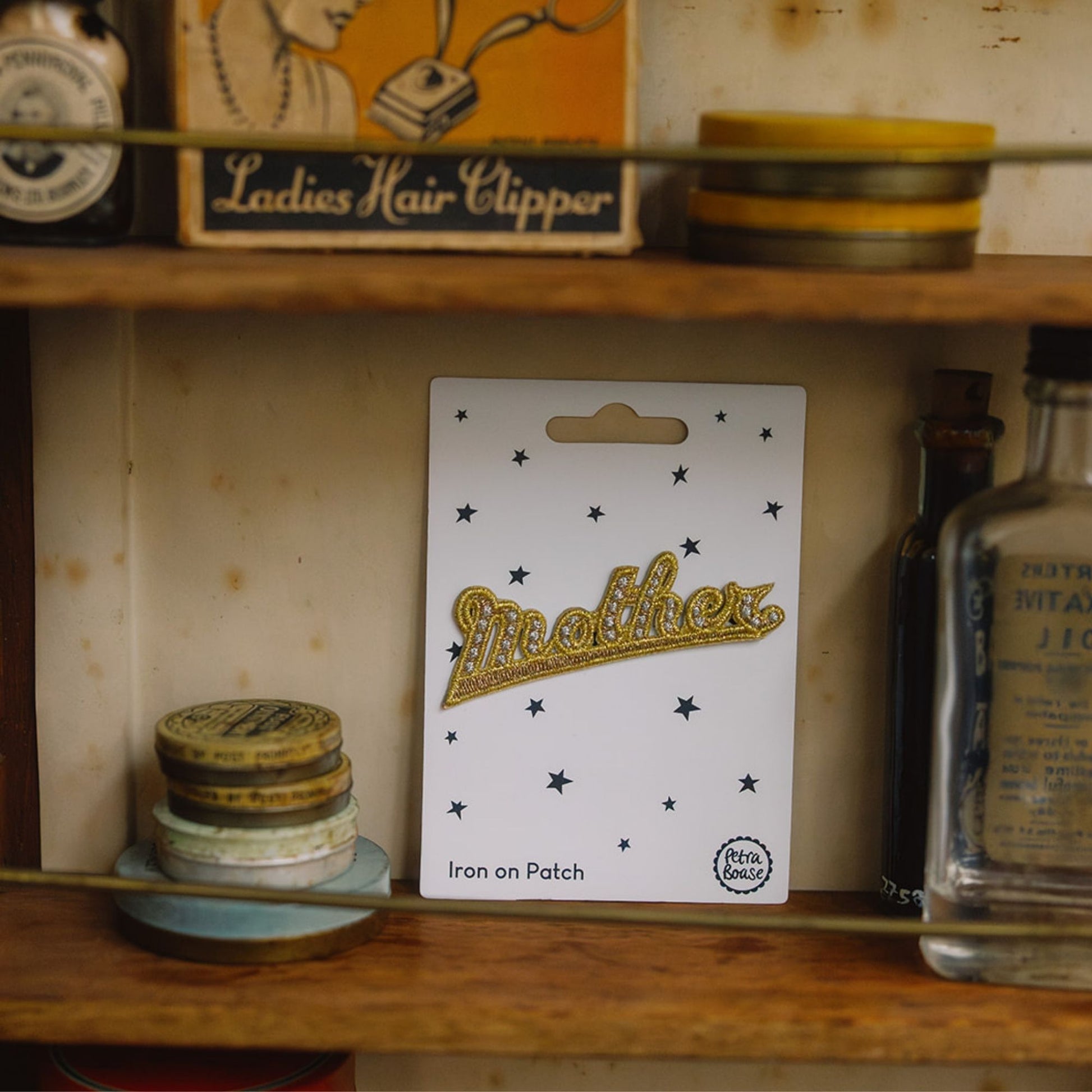 Embroidered gold mother retro patch in a vintage cuboard