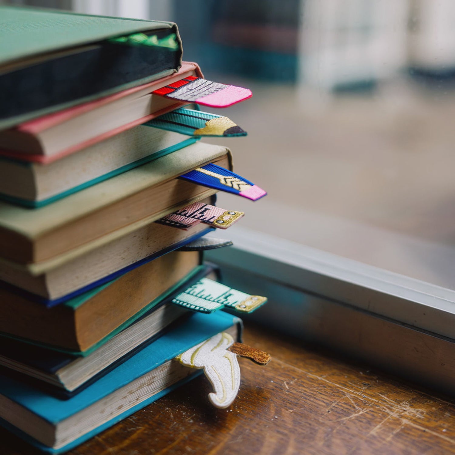 Petra Boase | Embroidered Fabric Bookamarks in pile of books