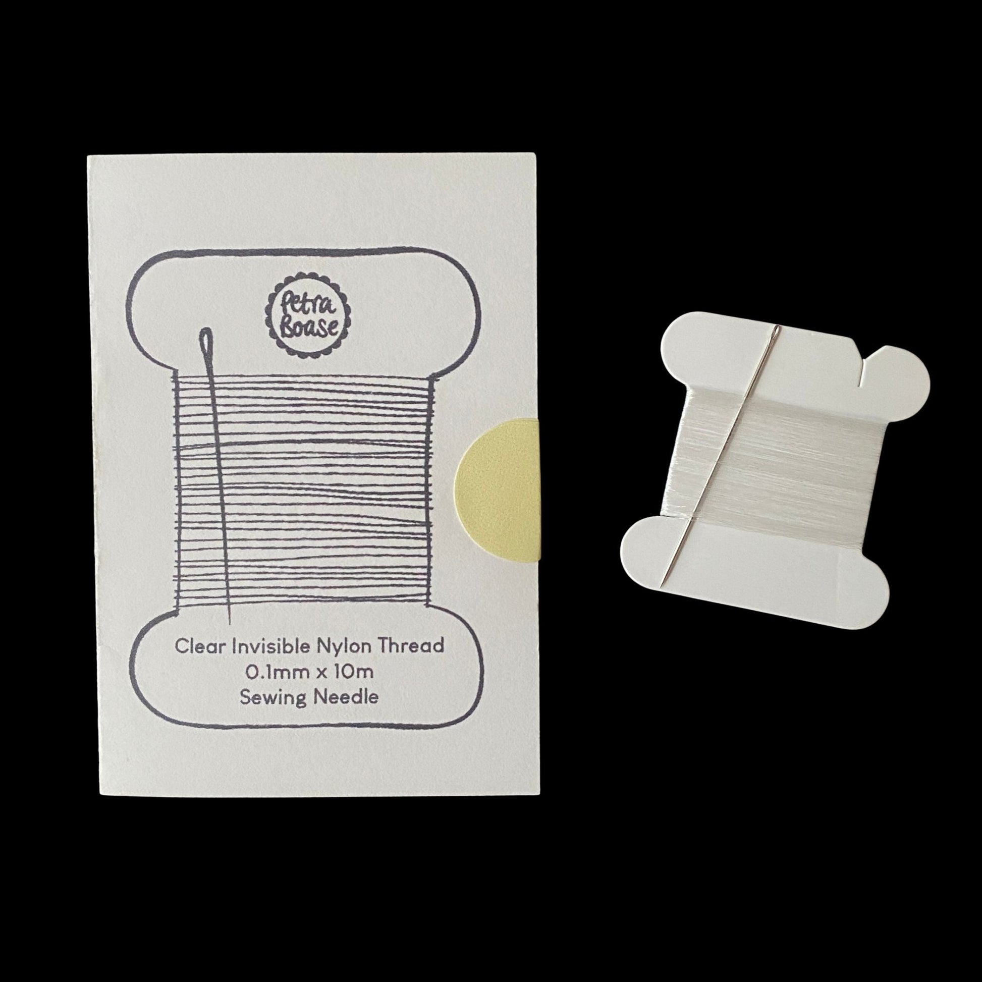 Clear invisible nylon thread spool with packaging on a white background