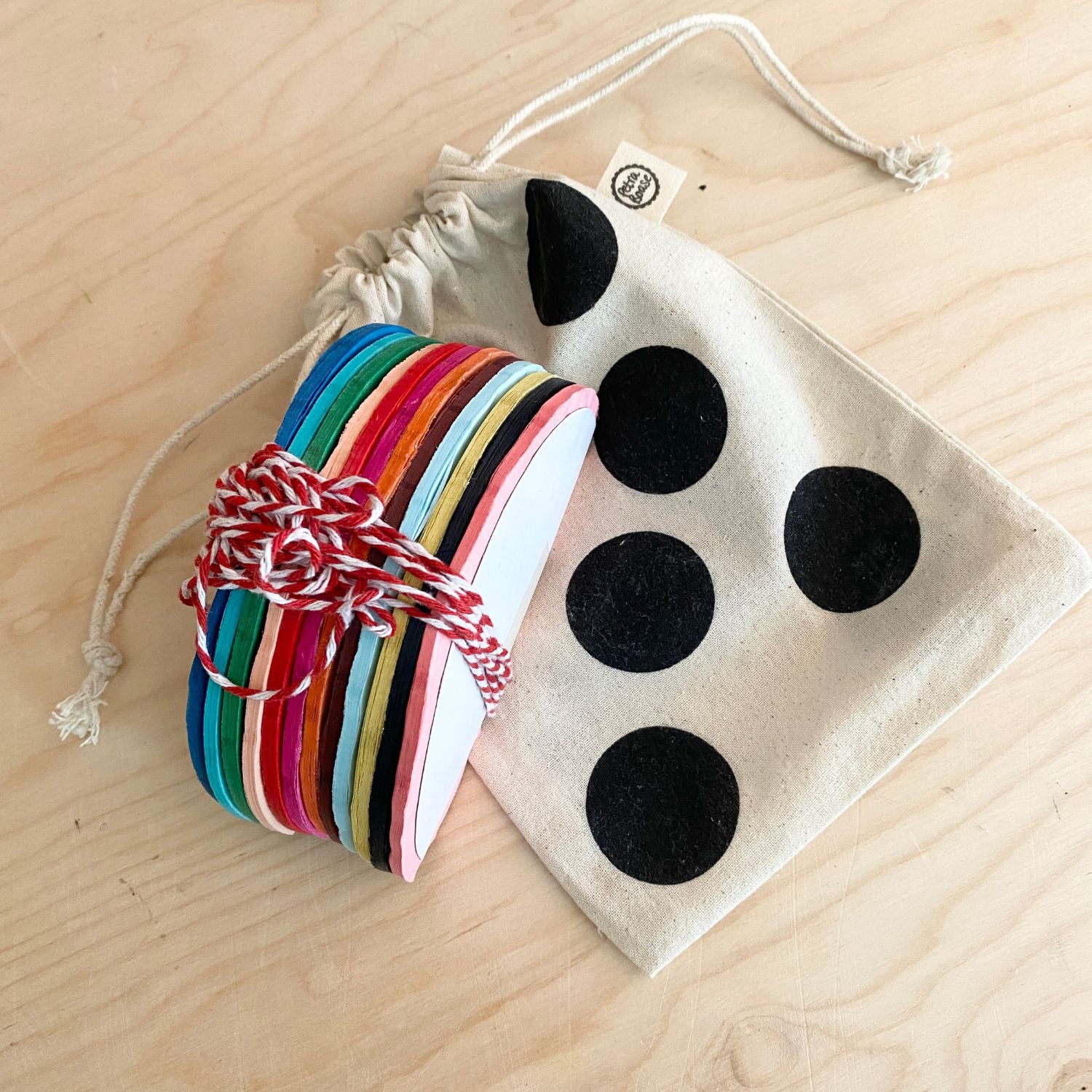 Petra Boase | Colourful Paper ball garland  eco christmas decorations in spotty bag