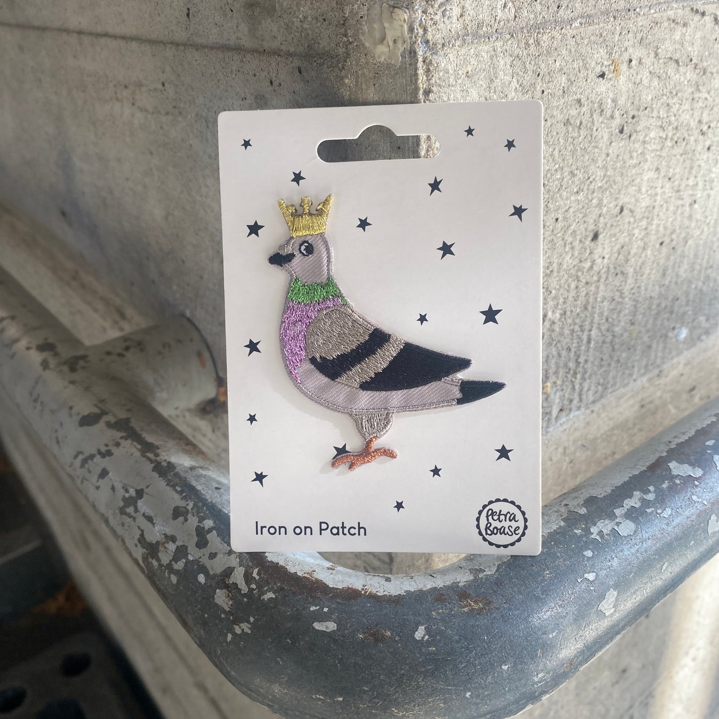 Iron on patch of a pigeon with a crown on a card, brand 'Petra Boase' visible