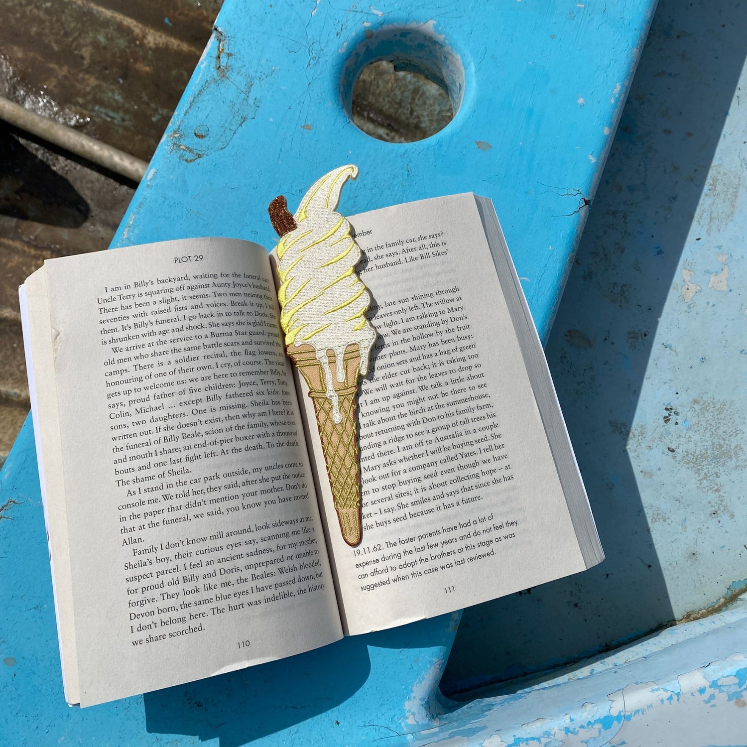 Ice cream cone bookmark on an open book with a blue background
