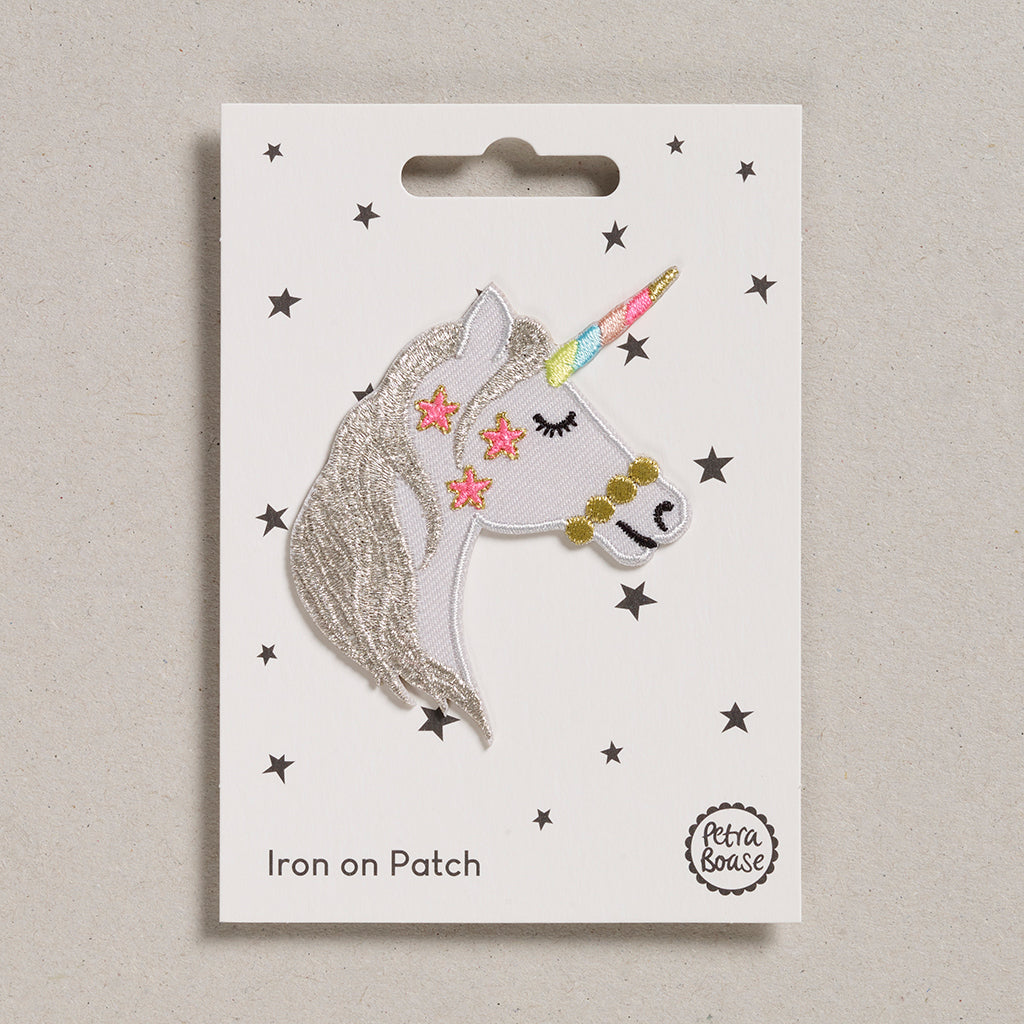 This patch is a sweet unicorn head in profile with silver mane, pink stars on the cheek, golden bridle and pastel rainbow striped horn.